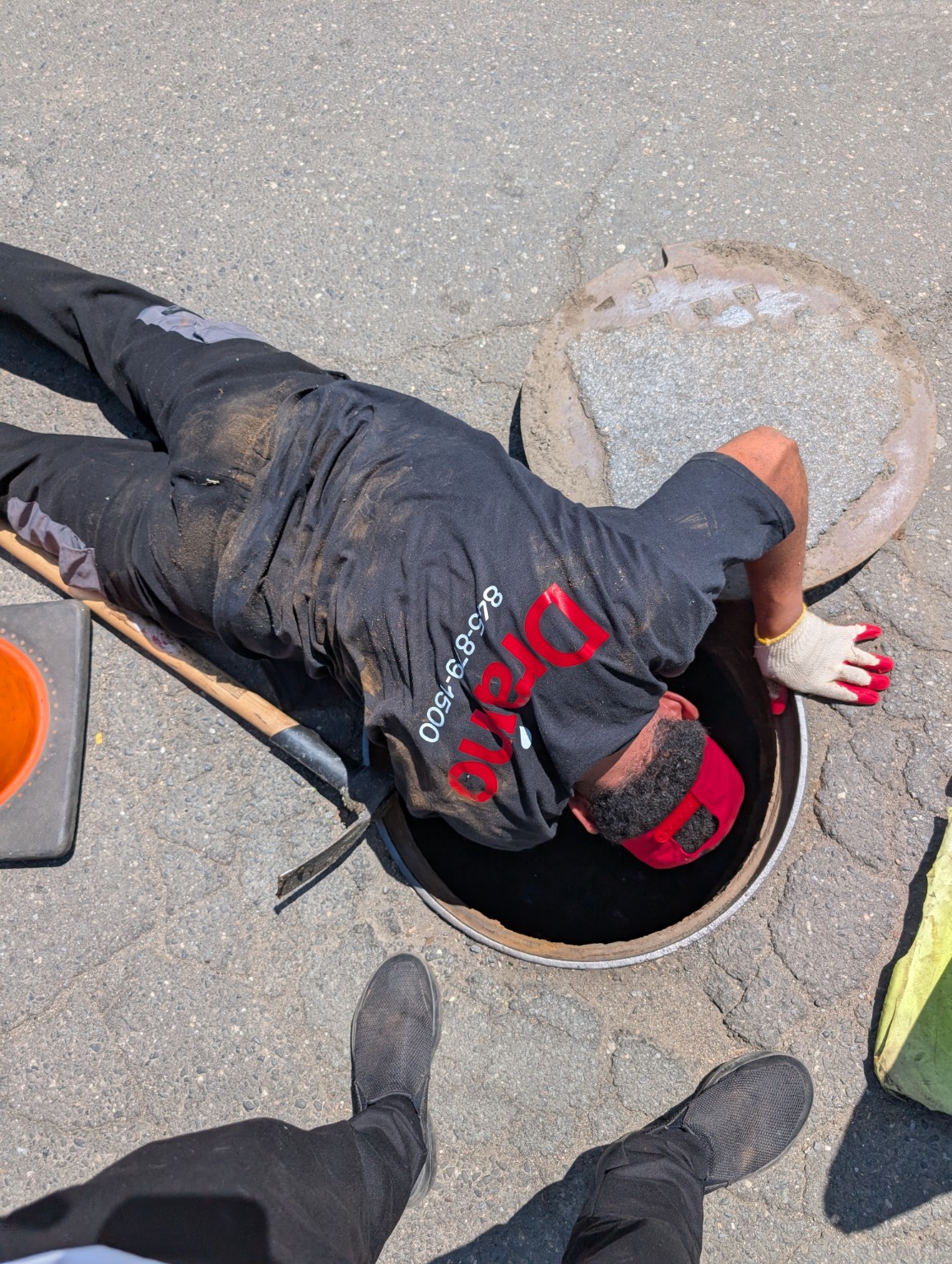 Draino technician inspecting a manhole