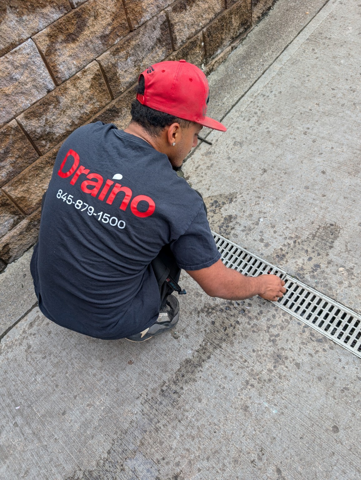 Draino technician checking an outside drain