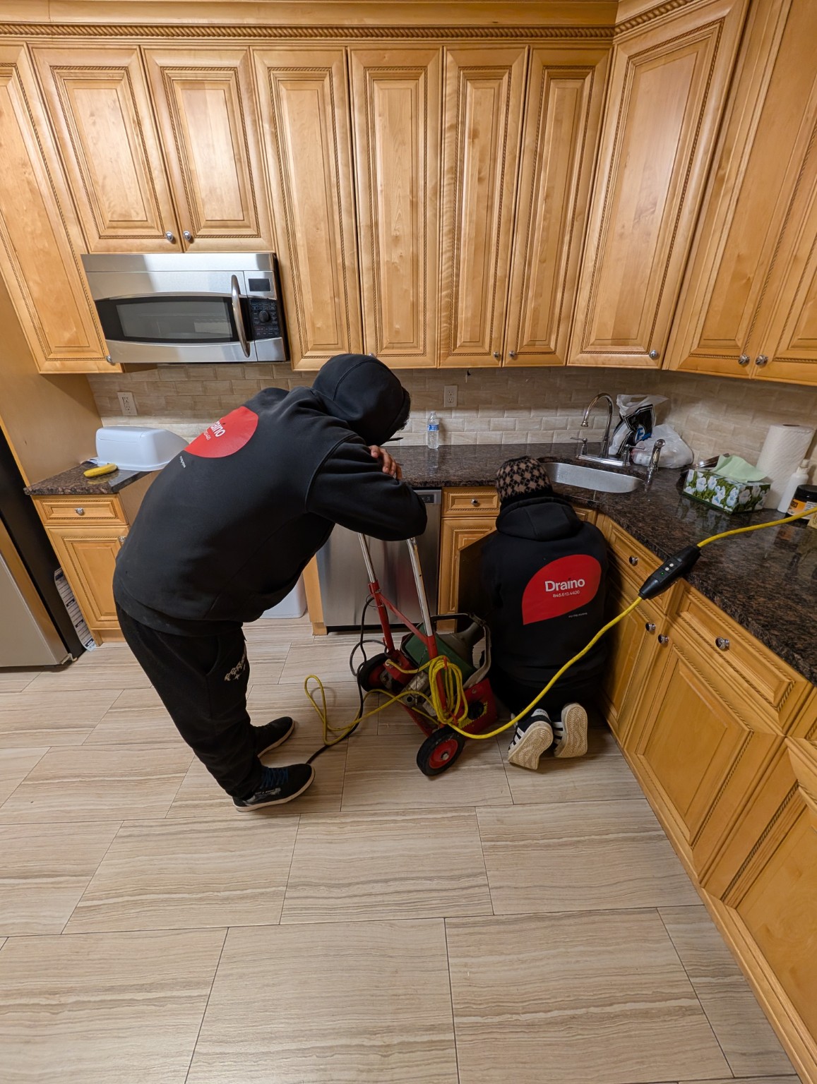 Draino crew working in a kitchen